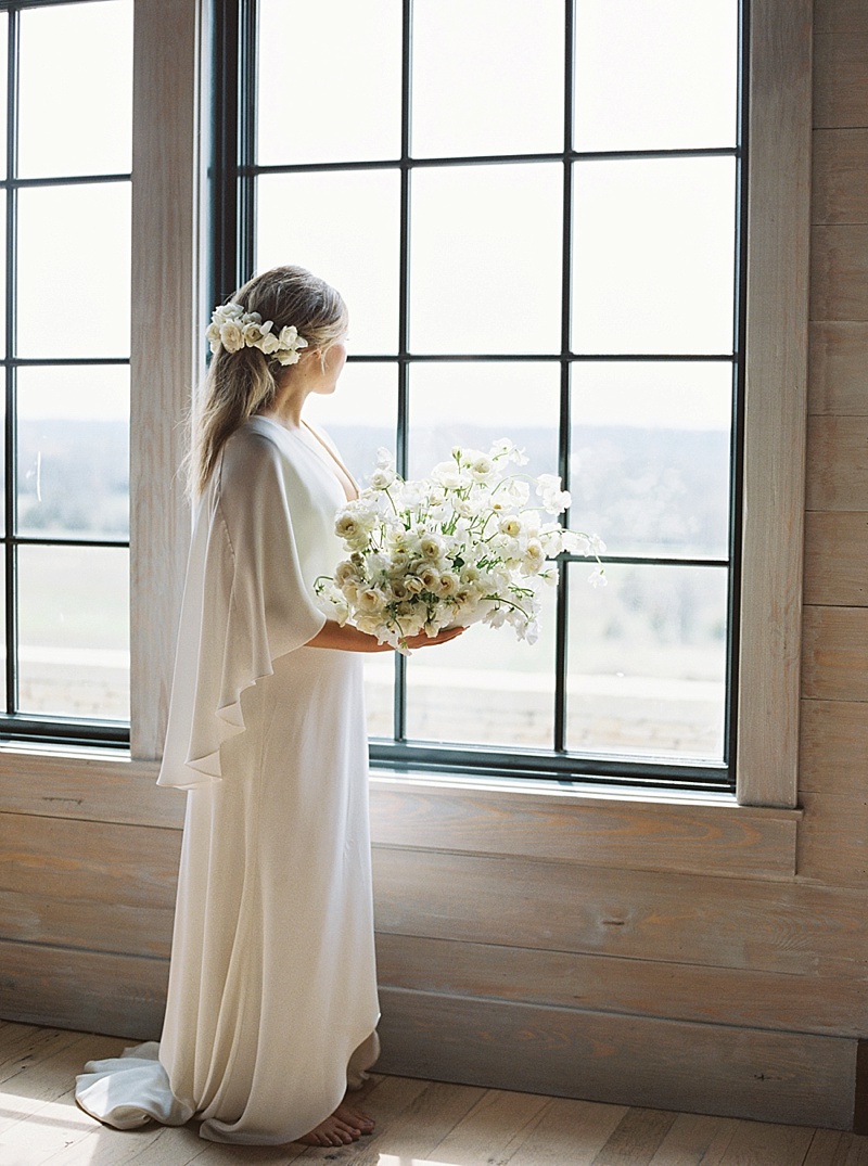 bride looking out Ashbourne Farms window 