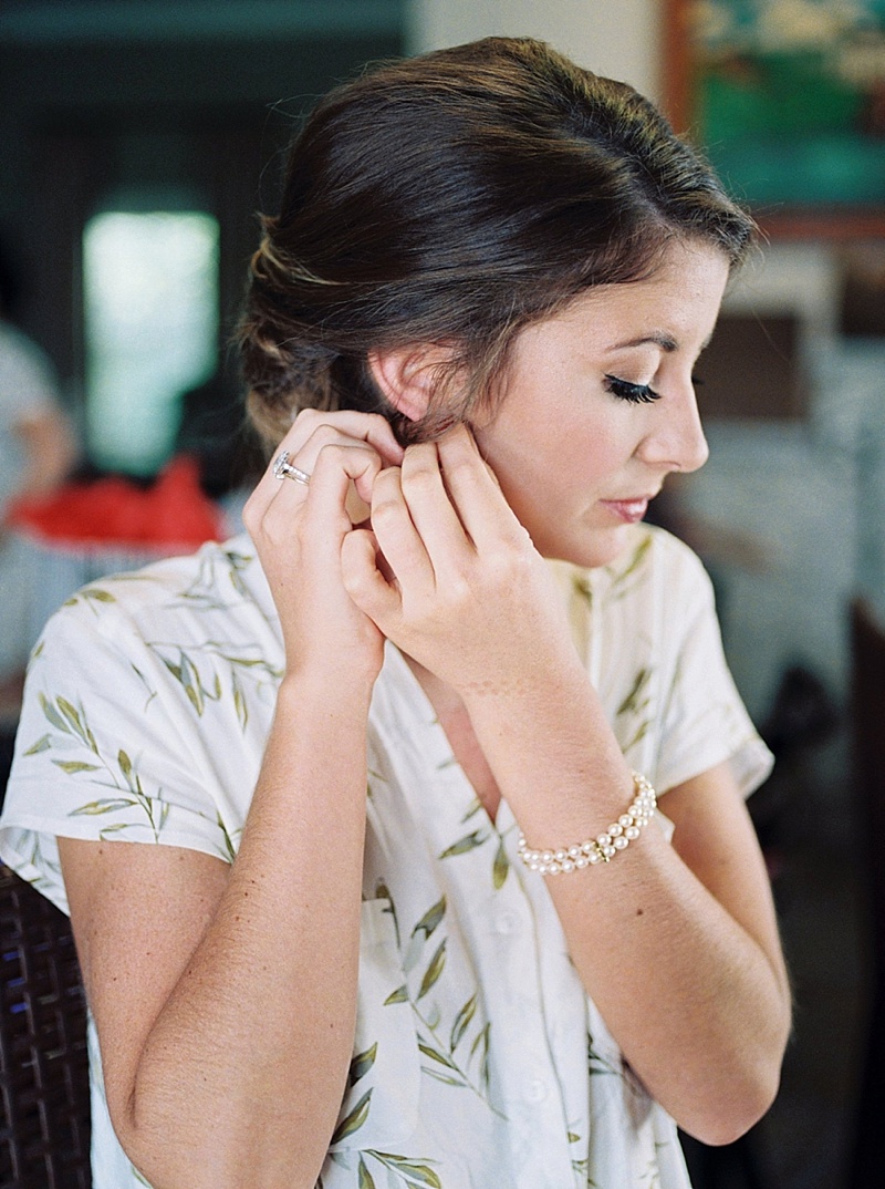 bride putting earrings in
